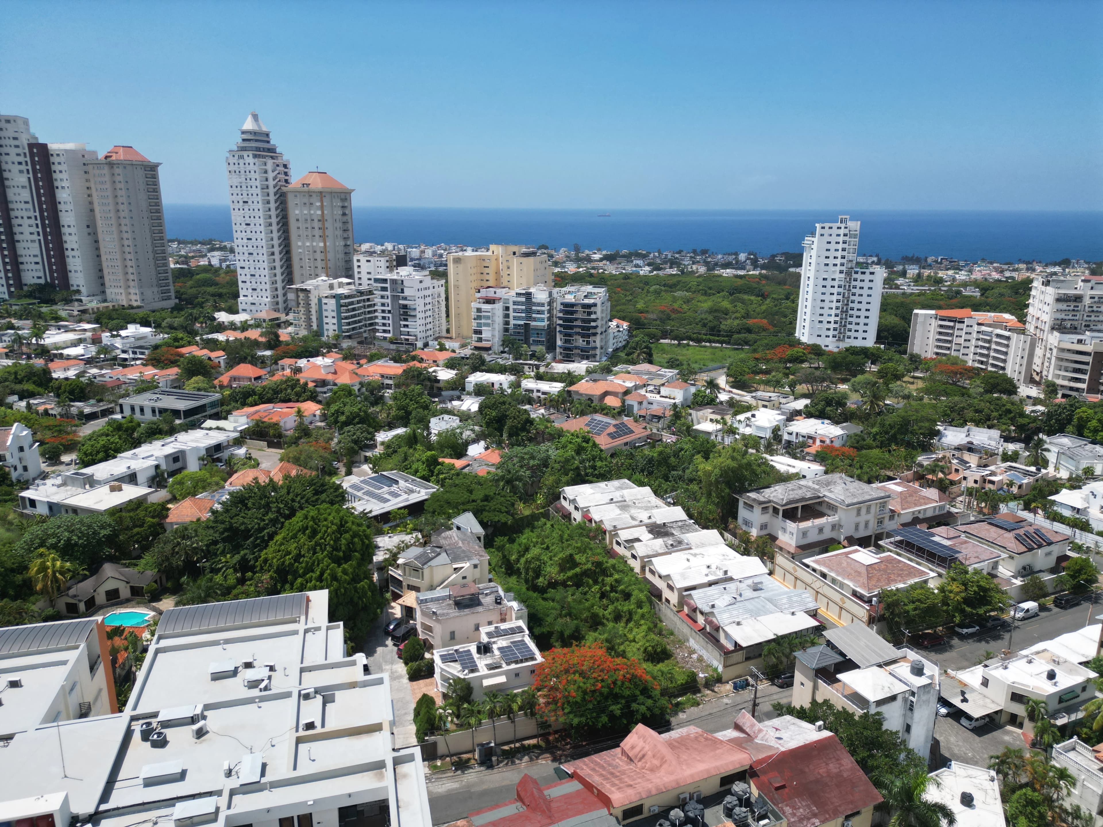 Drone view of residential development site in Los Cacicazgos overlooking Santo Domingo and the sea