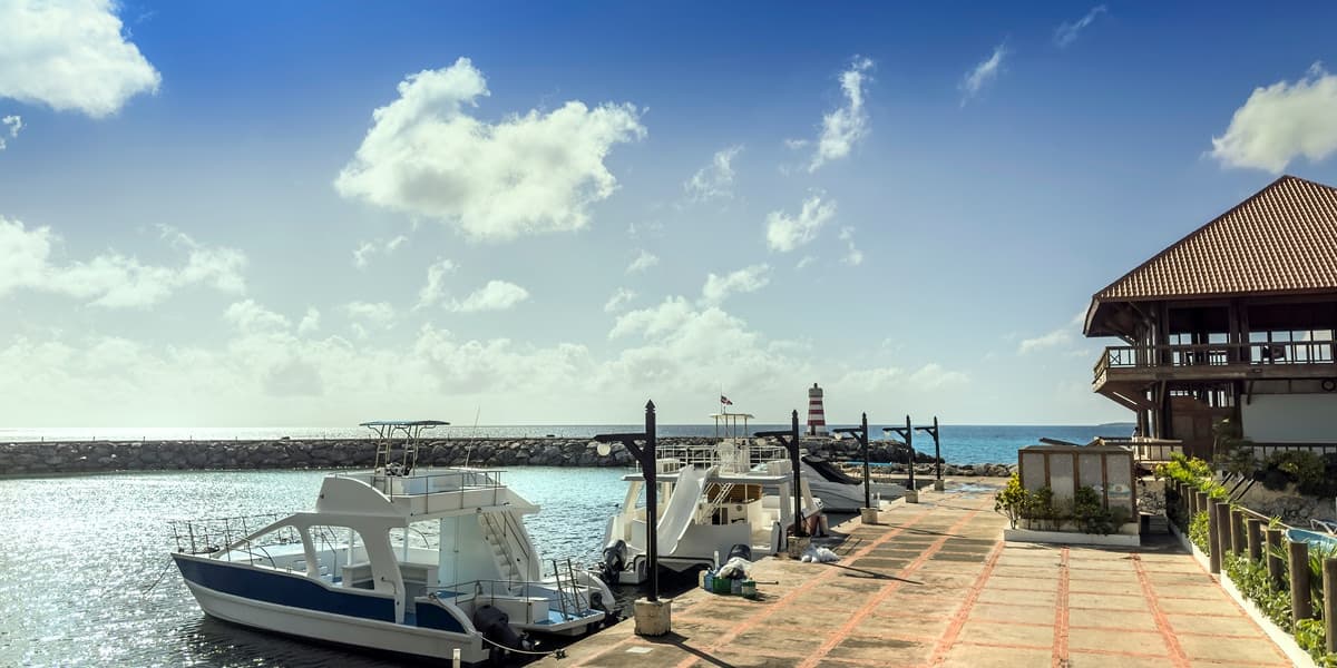 Luxury marina in the Dominican Republic, with yachts, calm water, and an elegant waterfront setting.